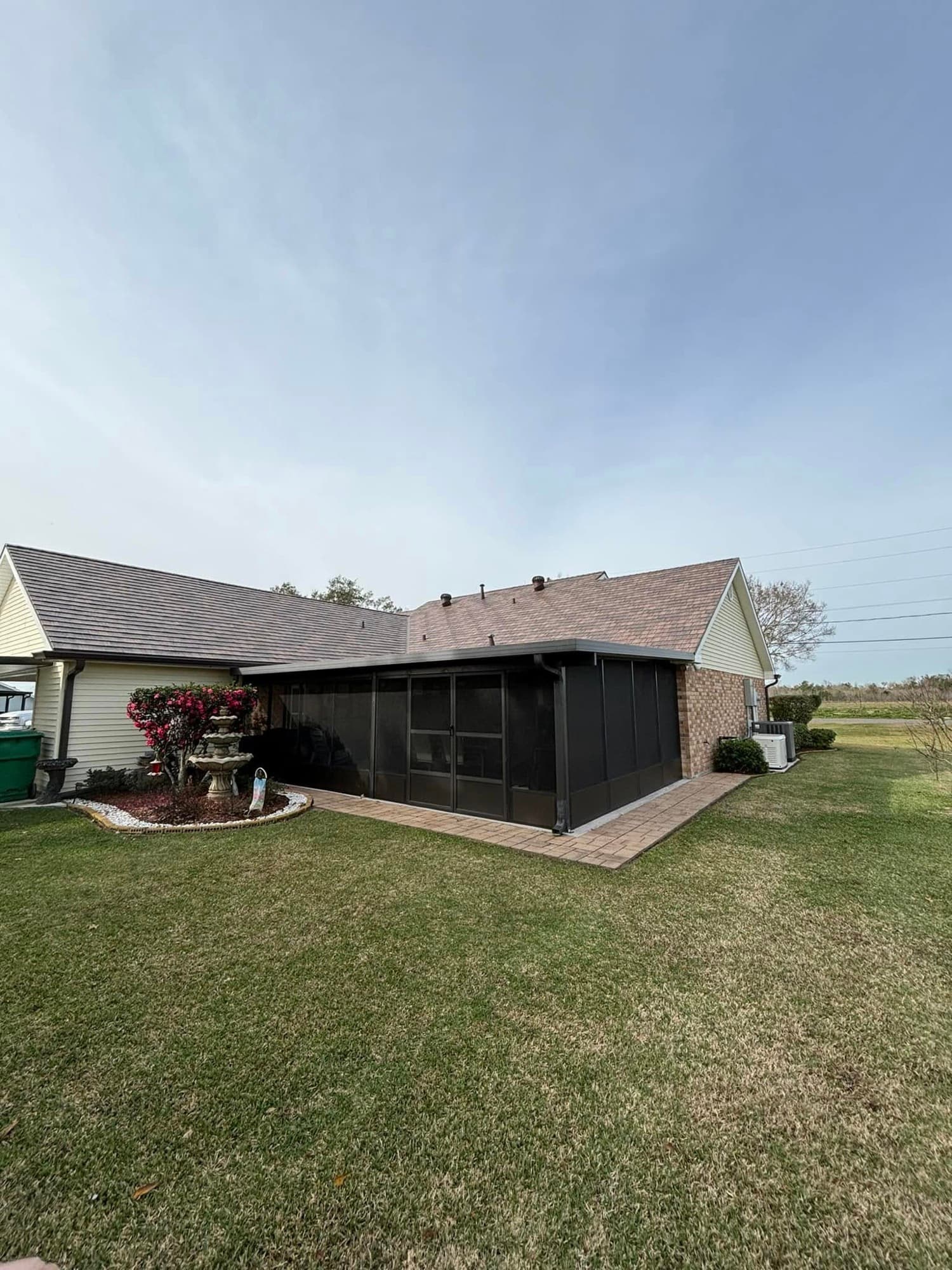 Brick home with screened patio addition built by Foret Construction in Lafourche Parish
