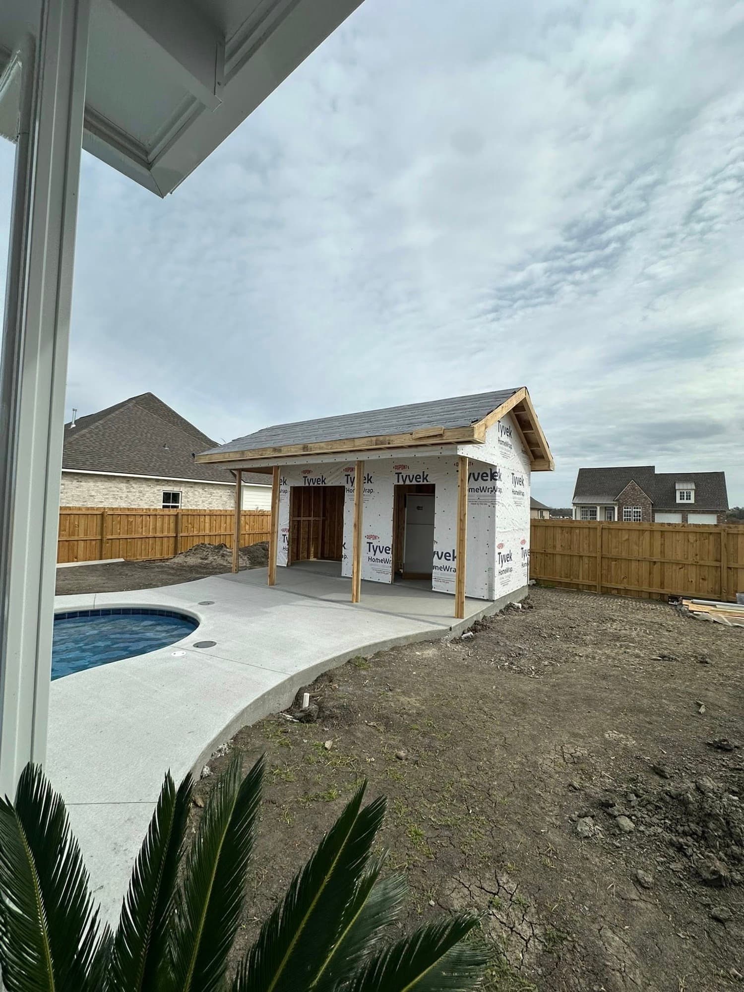 Pool house addition under construction with Tyvek wrap — Lafourche Parish