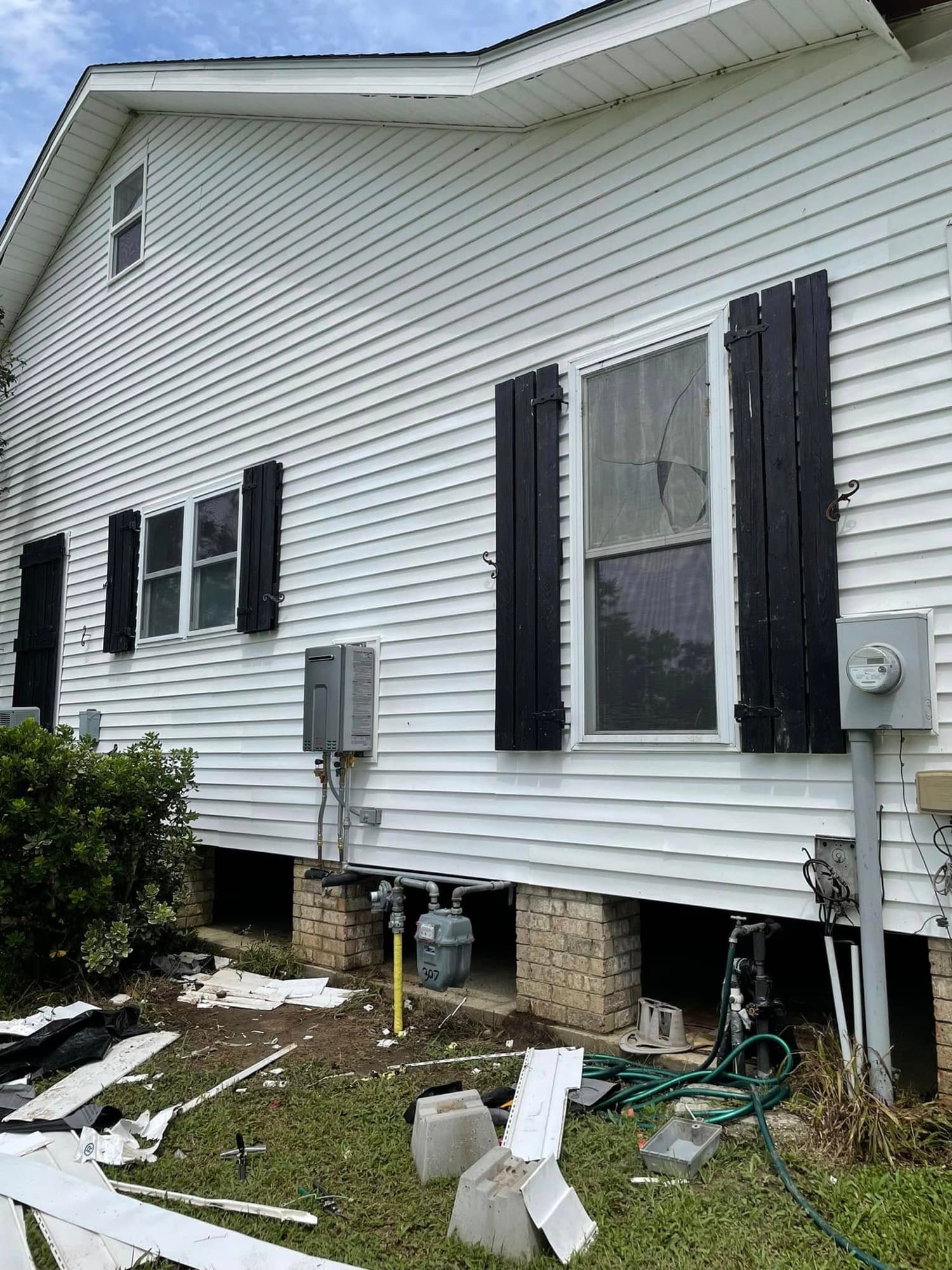 Two-story home with vinyl siding and black shutters — exterior update