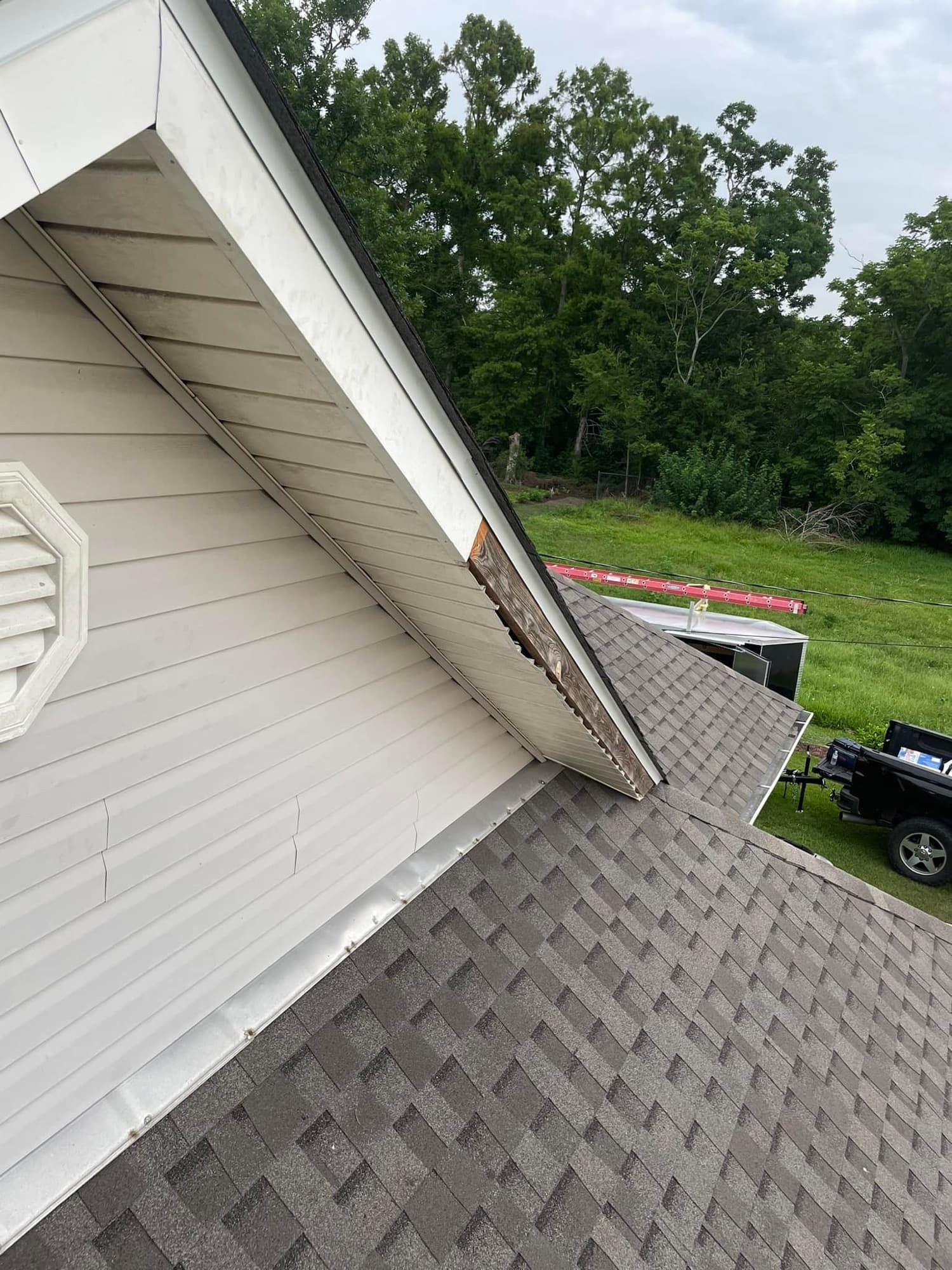 Detail of new gable shingle roof against white siding — Raceland, LA