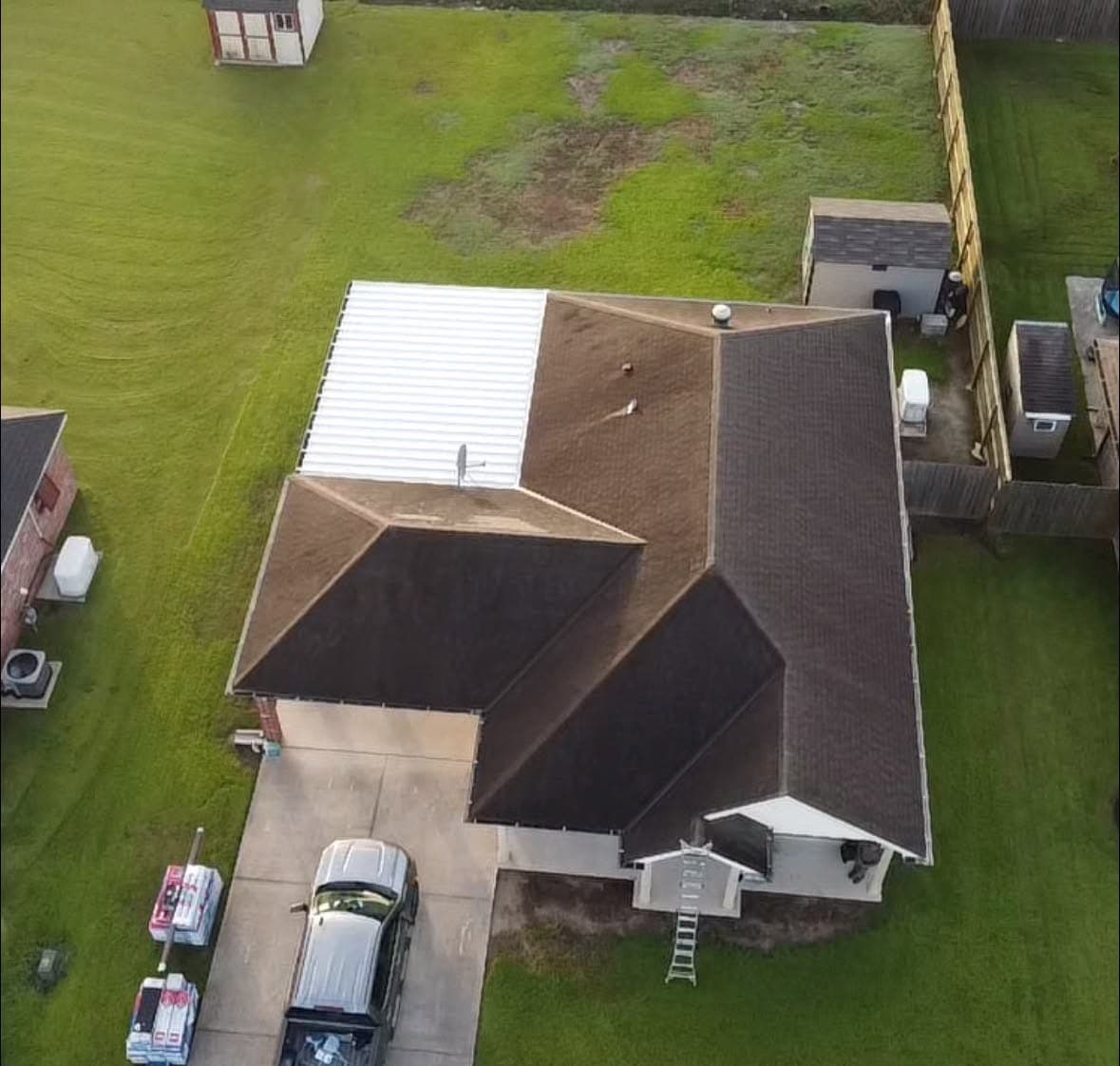 Drone view of an aged, streaked shingle roof at the start of a Foret Construction roof replacement — south Louisiana